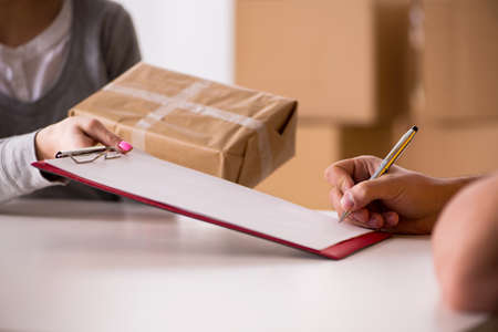 Delivery man delivering parcel boxの写真素材