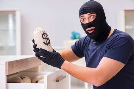 Robber wearing balaclava stealing valuable thingsの写真素材