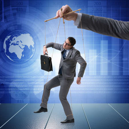 Businessman puppet being manipulated by bossの写真素材