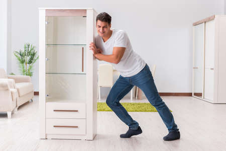Man moving furniture at homeの写真素材