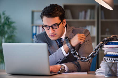 Businessman staying in the office for long hoursの写真素材