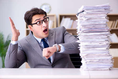 Businessman struggling to meet challenging deadlinesの写真素材