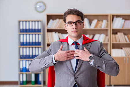 Superhero businessman working in the officeの写真素材