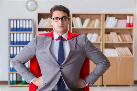 Superhero businessman working in the officeの写真素材