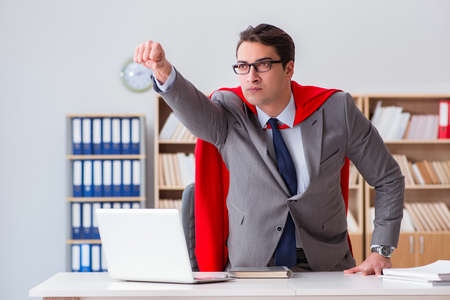 Superhero businessman working in the officeの写真素材