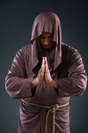 Monk in religious concept on gray backgroundの写真素材