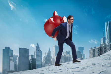 Businessman carrying the piggybank with savings