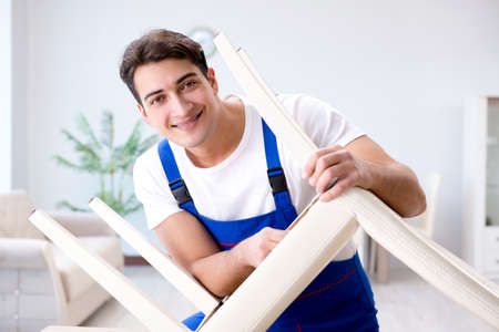 Man repairing chair in the roomの写真素材