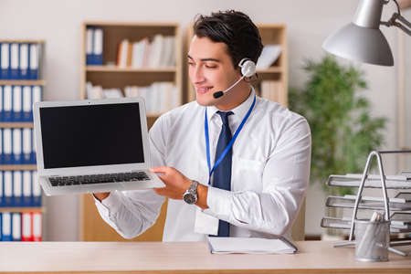 Handsome customer service clerk with headsetの写真素材