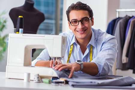 Young man tailor working on new clothing