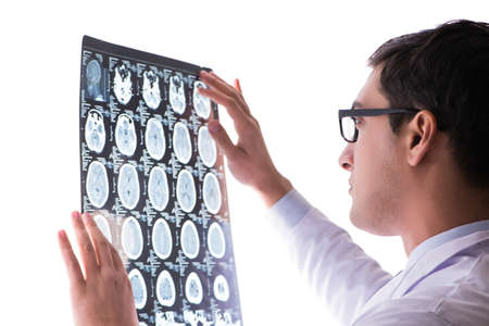 Young doctor looking at computer tomography x-ray imageの写真素材