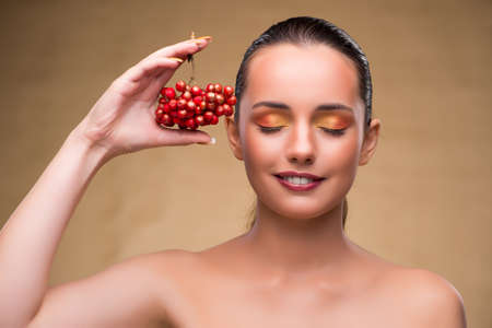Young pretty woman with berries in beauty conceptの写真素材