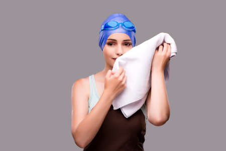 Woman swimmer against grey backgroundの写真素材