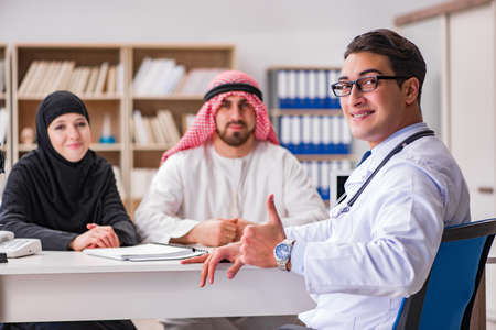 Doctor consulting arab family at hospitalの写真素材