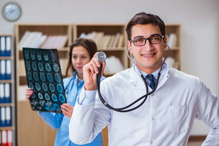 Young doctor looking at computer tomography x-ray image
