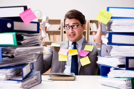 Businessman struggling with multiple prioritiesの写真素材