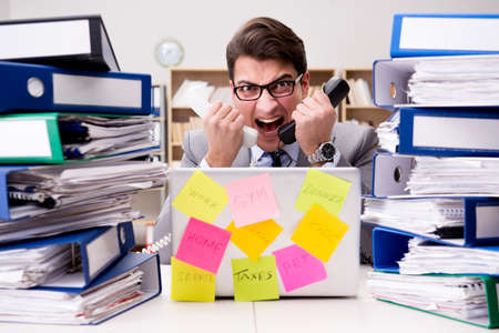 Businessman struggling with multiple prioritiesの写真素材