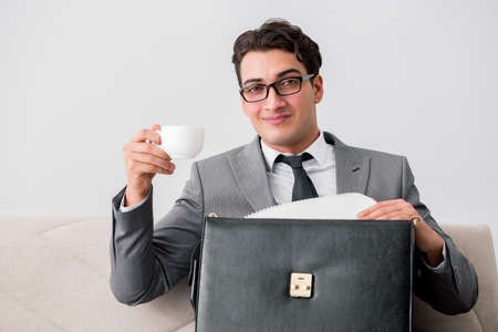 Businessman with briefcase in business conceptの写真素材