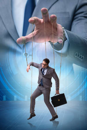 Businessman puppet being manipulated by bossの写真素材