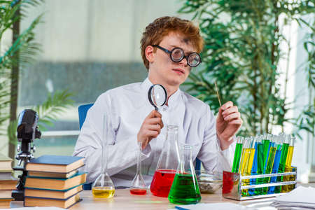 Young crazy chemist working in the labの写真素材