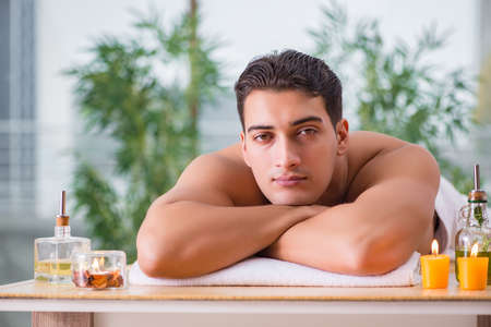 Handsome man during spa massaging sessionの写真素材