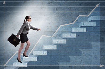 Young businesswoman climbing career ladderの写真素材