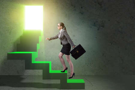 Young businesswoman climbing career ladderの写真素材