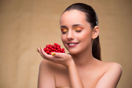 Young pretty woman with berries in beauty conceptの写真素材