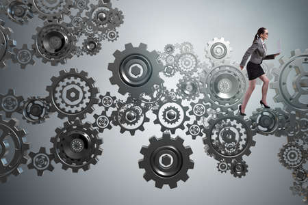 Woman businesswoman walking in cogwheelsの写真素材