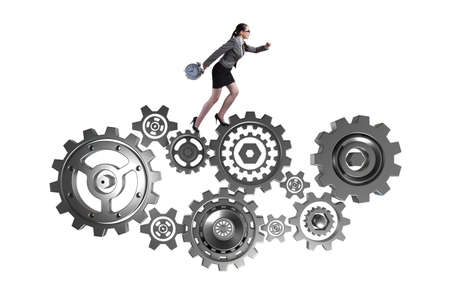 Woman businesswoman walking in cogwheels isolated on whiteの写真素材