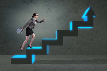 Young businesswoman climbing career ladderの写真素材