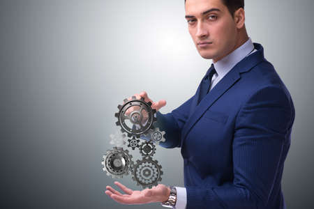 Businessnman in teamwork concept with cogwheelsの写真素材