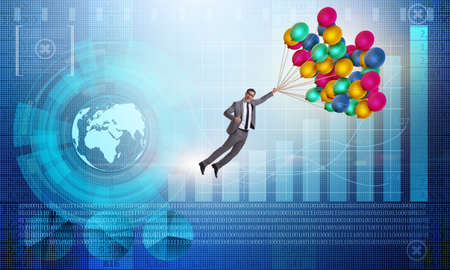 Businessman flying on balloons over graphの写真素材