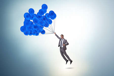 Businessman flying on balloon in challenge conceptの写真素材
