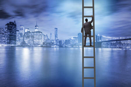 Young businessman climbing career ladderの写真素材