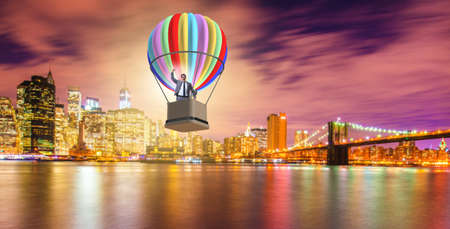 Businessman flying on balloon in challenge conceptの写真素材
