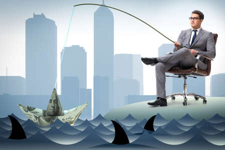 Businessman fishing out dollars from waterの写真素材