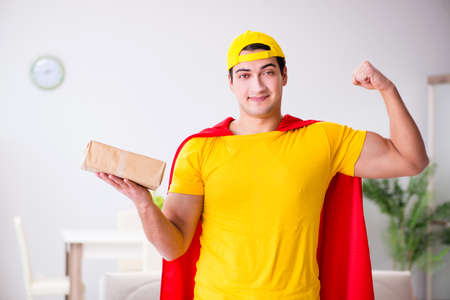 Superhero delivery guy with boxの写真素材