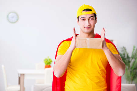 Superhero delivery guy with boxの写真素材