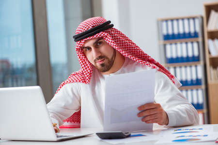 Arab businessman working on laptop computerの写真素材