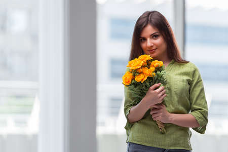 Young girl with present of flowersの写真素材