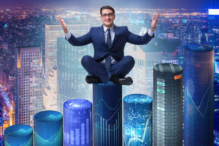 Businessman on the bar charts in business conceptの写真素材