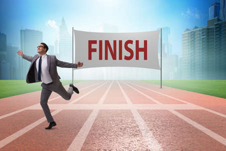 Businessman on the finishing line in competition conceptの写真素材