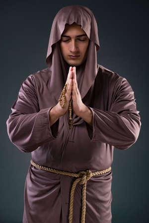 Monk in religious concept on gray backgroundの写真素材