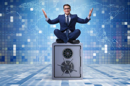 Businessman resting putting leg on safeの写真素材