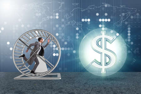 Business concept with businessman running on hamster wheelの写真素材