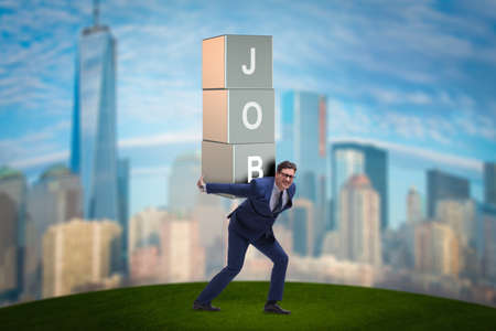 Businessman carrying the burden of his jobの写真素材