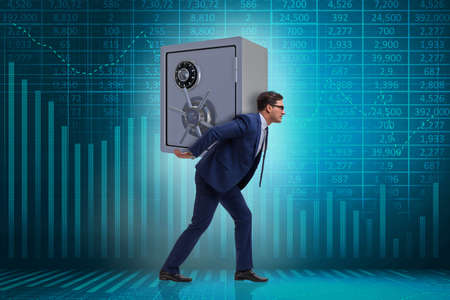 BUsinessman stealing metal safe from bankの写真素材