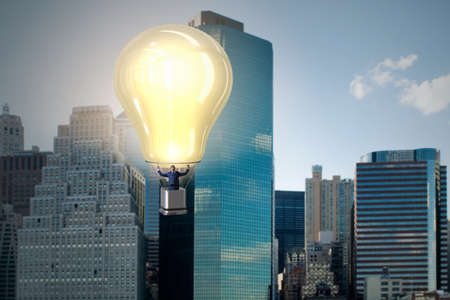 Businessman flying on hot balloonの写真素材