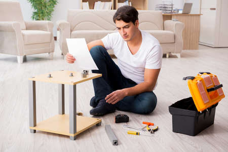 Man assembling shelf at homeの写真素材